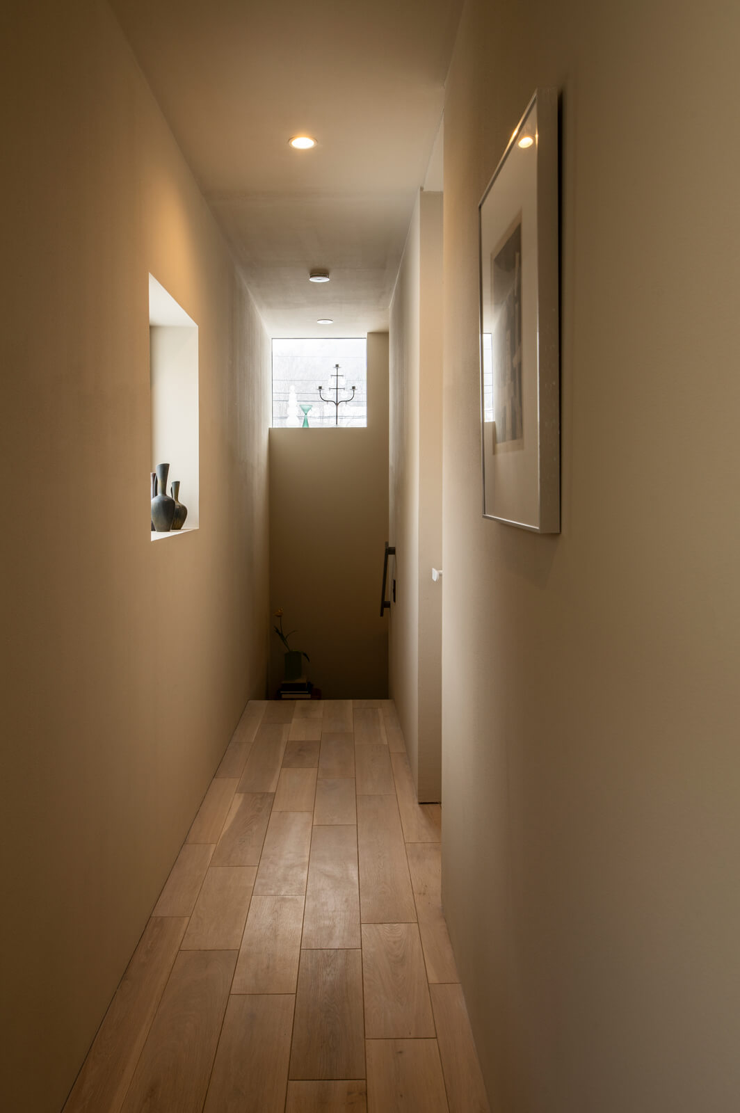 廊下の壁面にスイッチプレートがなく、見せたいものだけで空間が構成されている