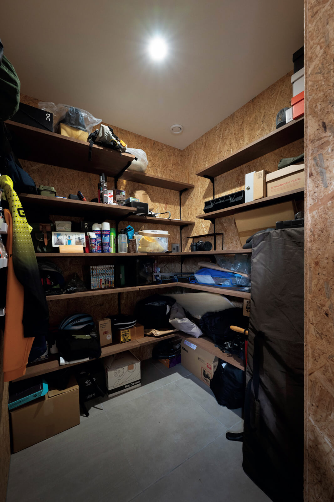 土間の奥にある趣味アイテム収納用の倉庫。棚の位置や寸法はTさんの要望をもとに設えた